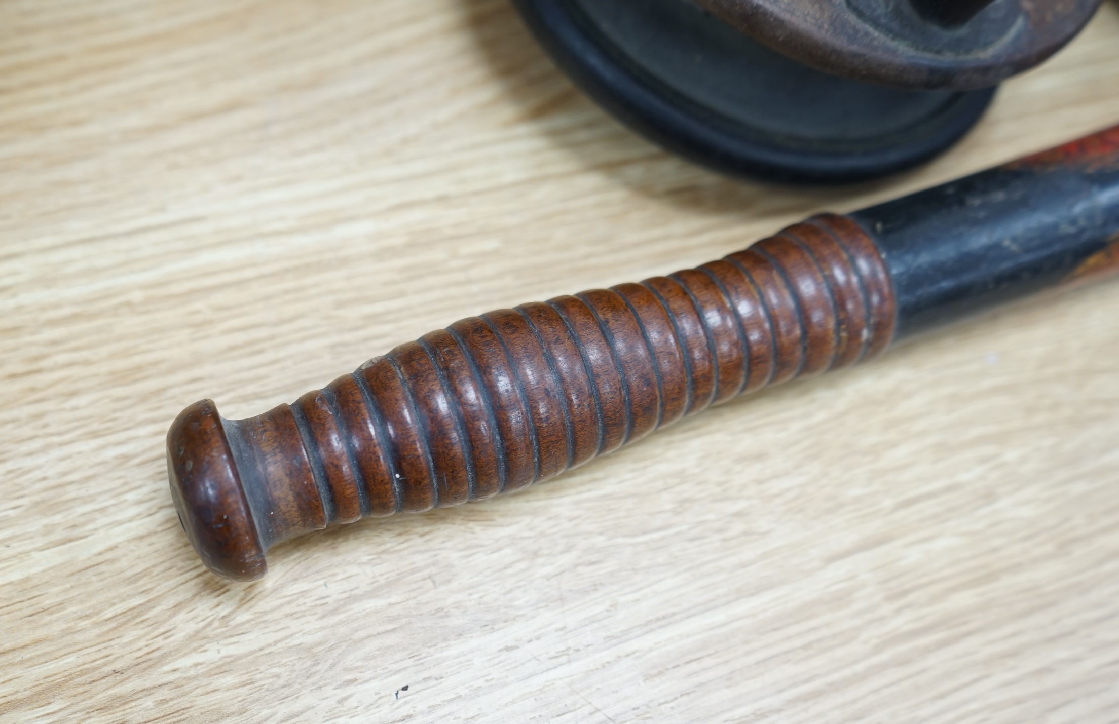 Two wooden fishing reels, a Victorian truncheon and an Arts and Crafts pewter box with enamel roundel. Truncheon 43cm long., Condition - all items worn